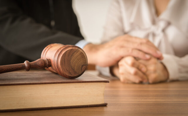 people holding hands near gavel