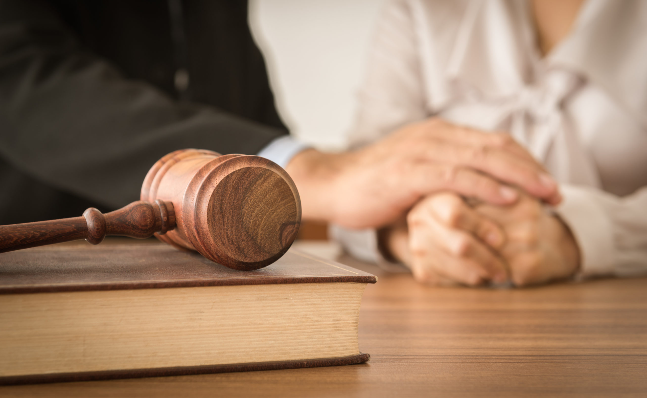people holding hands near gavel