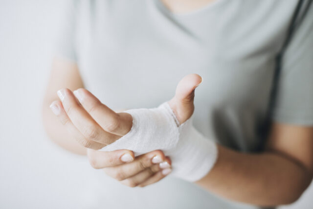 Woman with gauze bandage wrapped around her hand; Broward County Personal Injury Attorney concept image
