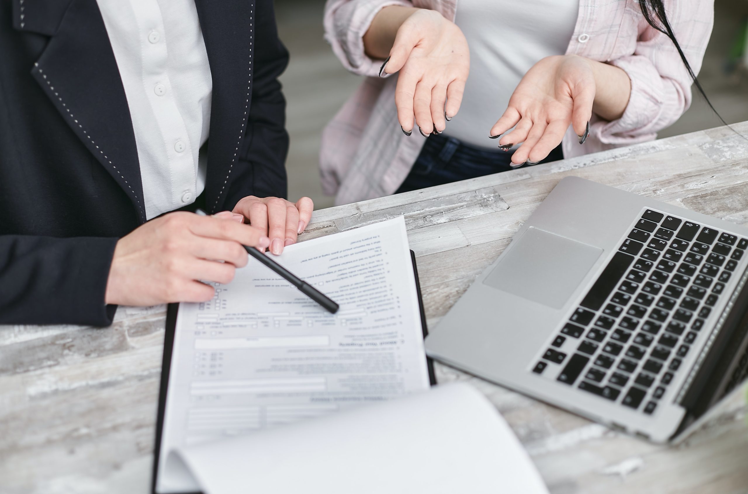 Broward Commercial Litigation Lawyer working with client at a desk