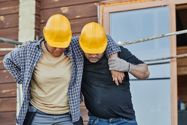 one co-worker helping injured employee