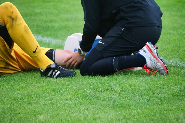 Injured athlete examined by athletic trainer