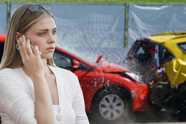 woman on phone in front of a car accident