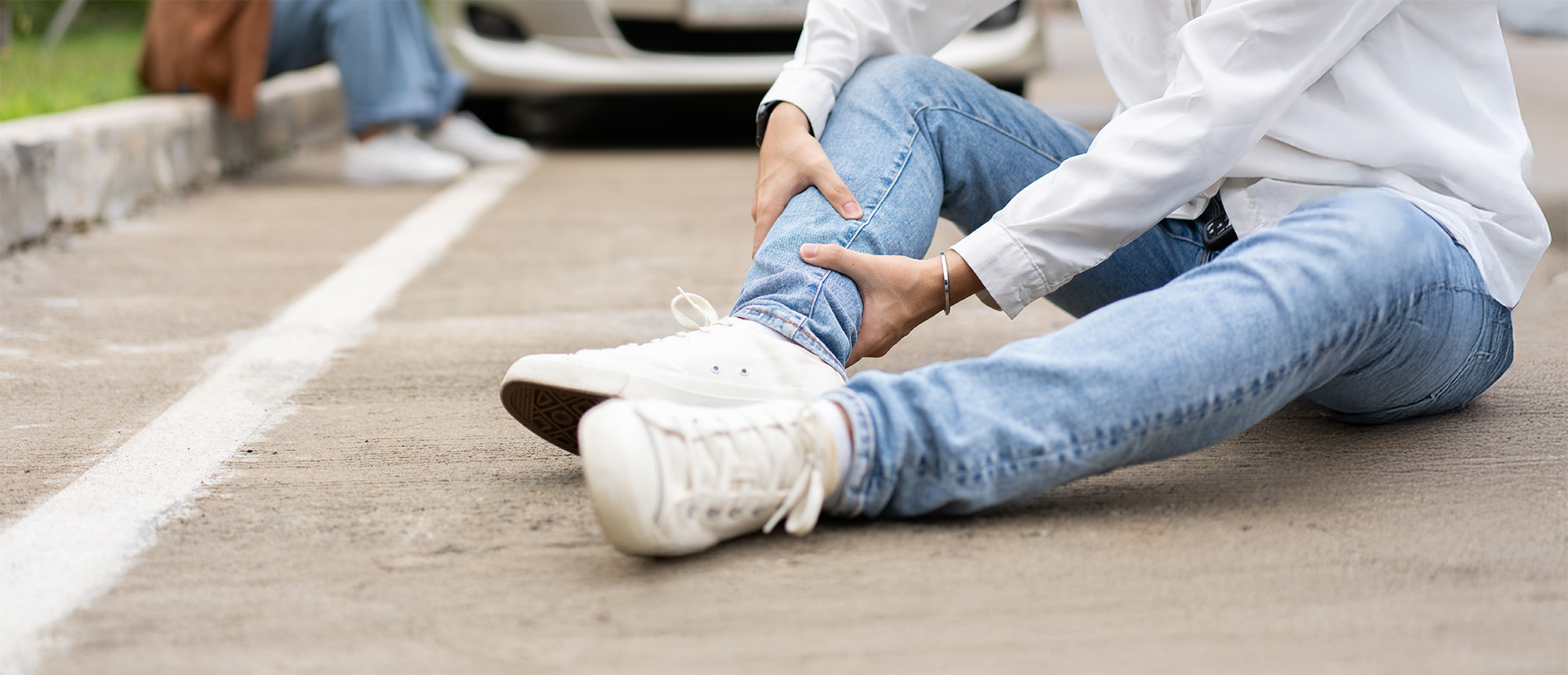 Man injured in car accident woman distressed in background