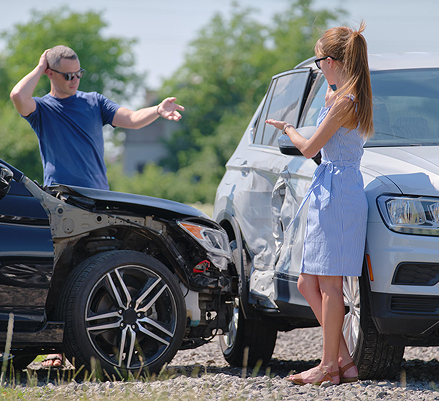 two drivers talking to each other after a car accident