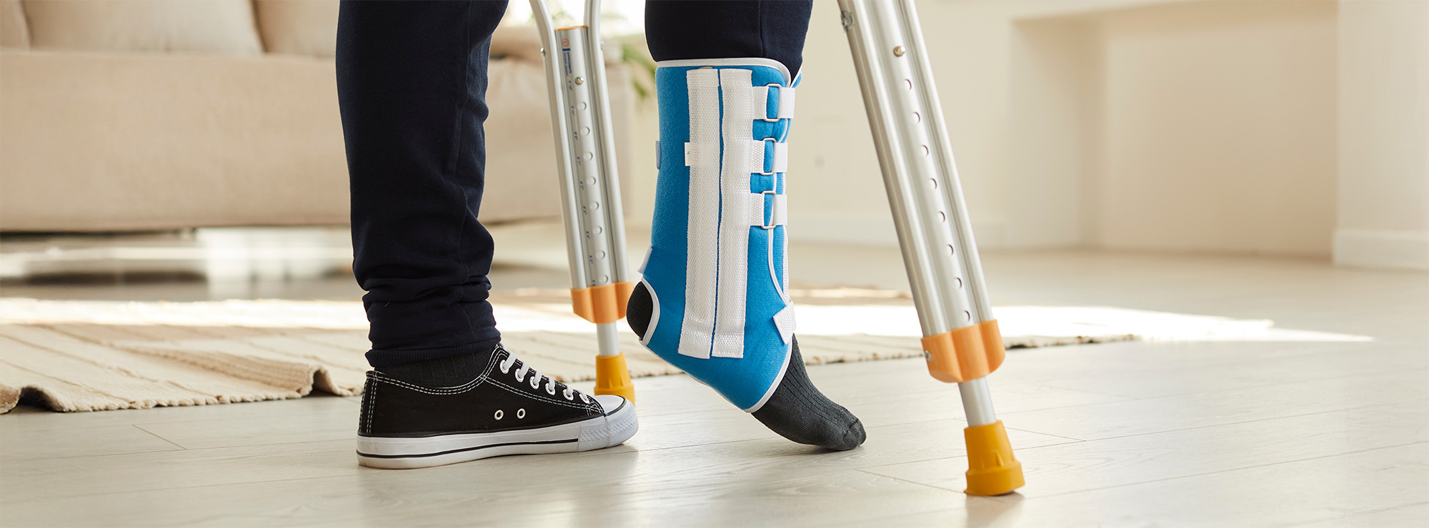 Unwell man with bandage on leg walk on crutches