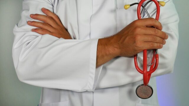doctor with crossed arms holding stethoscope