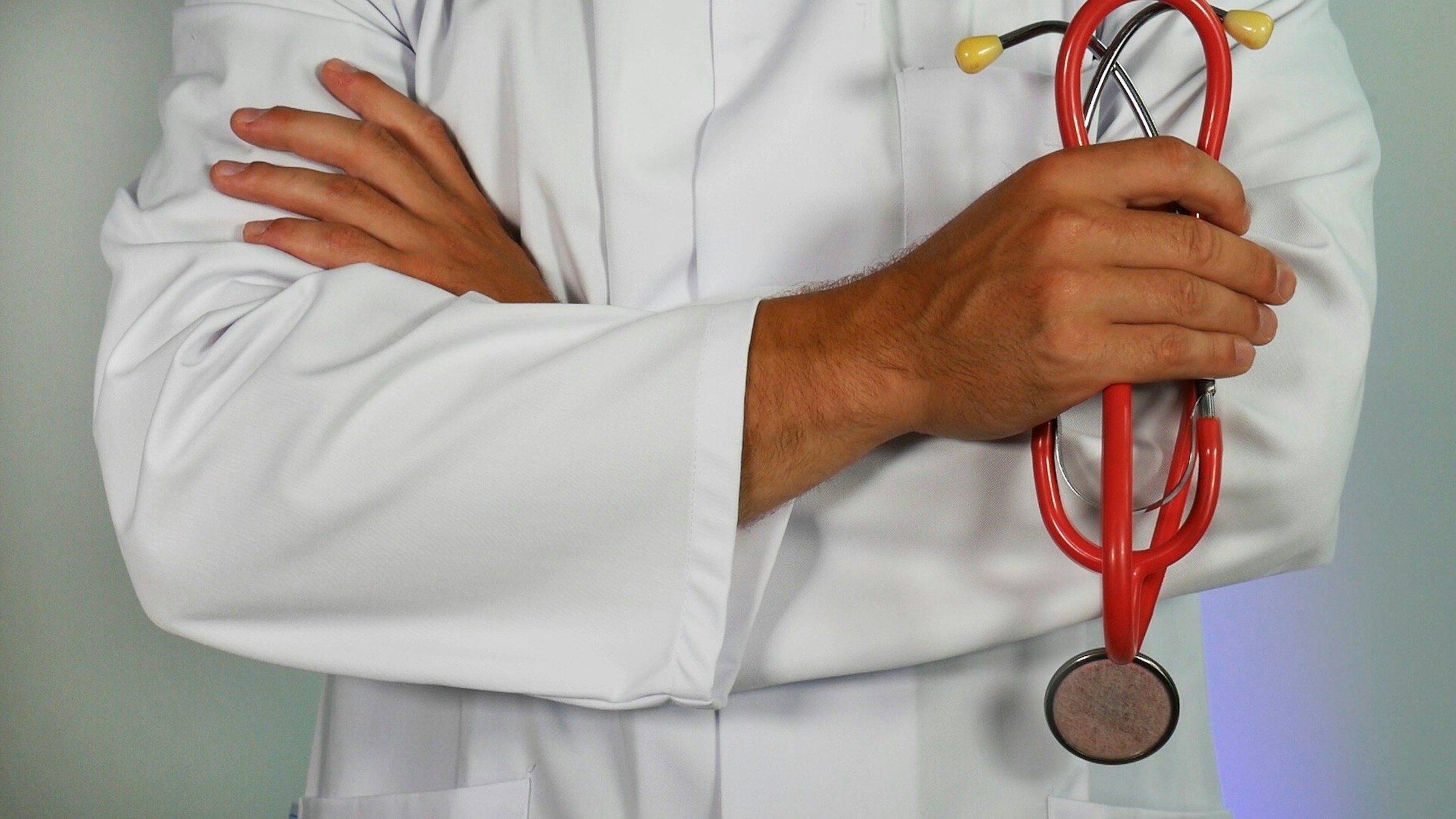 doctor with crossed arms holding stethoscope